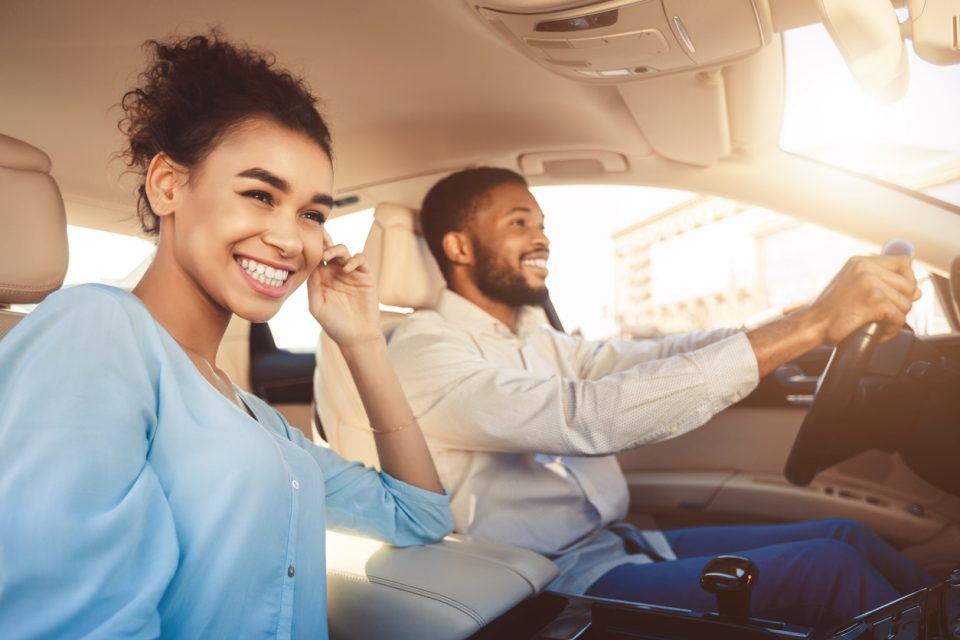 Young couple driving in car,