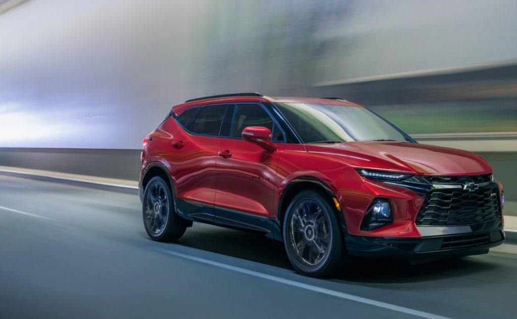 red blazer emerging from a blurred tunnel