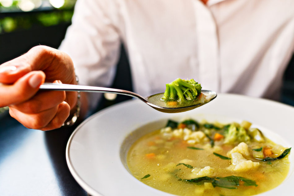 Woman Eating Vegetable Soup