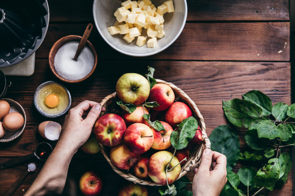 Woman baking cake with freshly picked apples