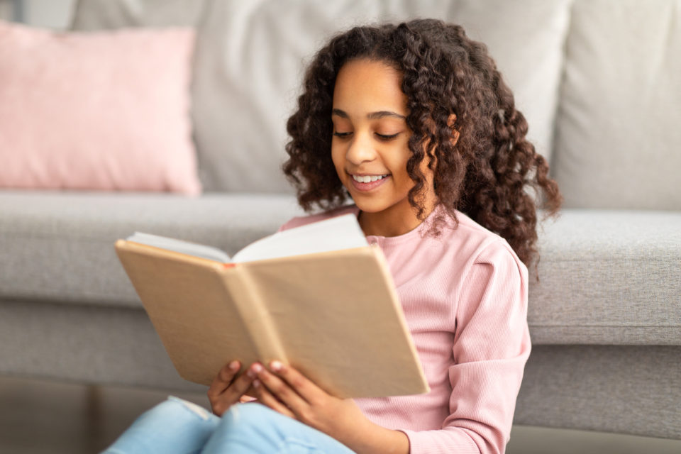 happy young girl reading book