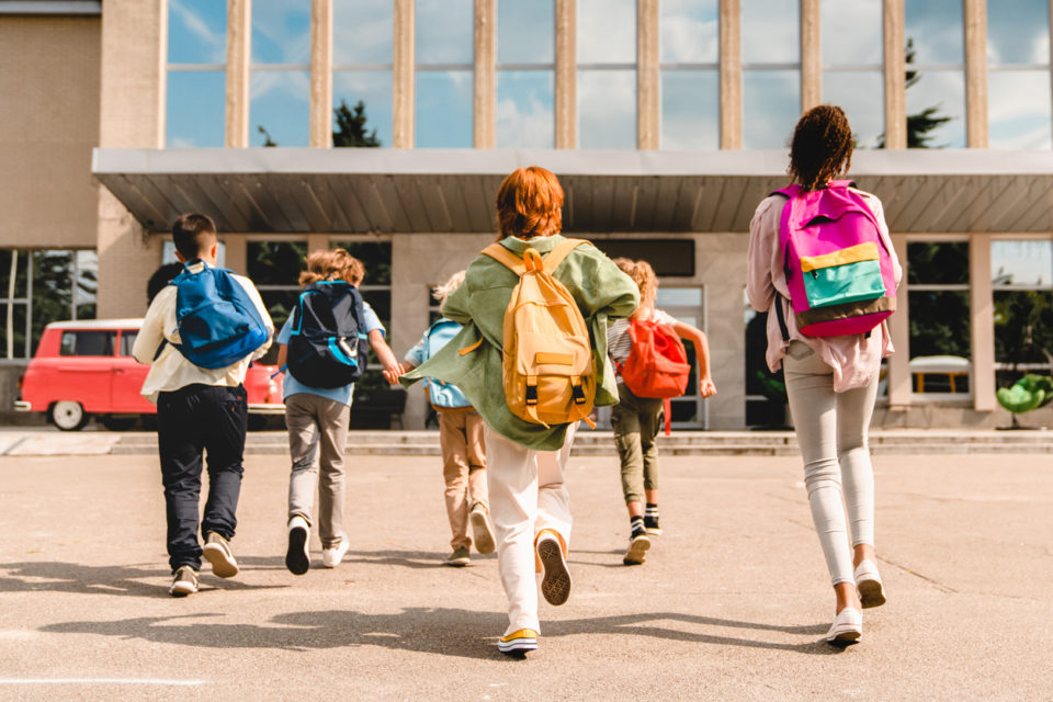 little kids running into school