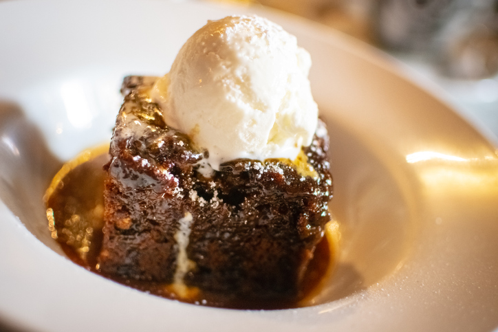 Sticky toffee pudding is a British dessert consisting of a very moist sponge cake, made with finely chopped dates, covered in a toffee sauce and often served with a vanilla custard or vanilla ice-cream