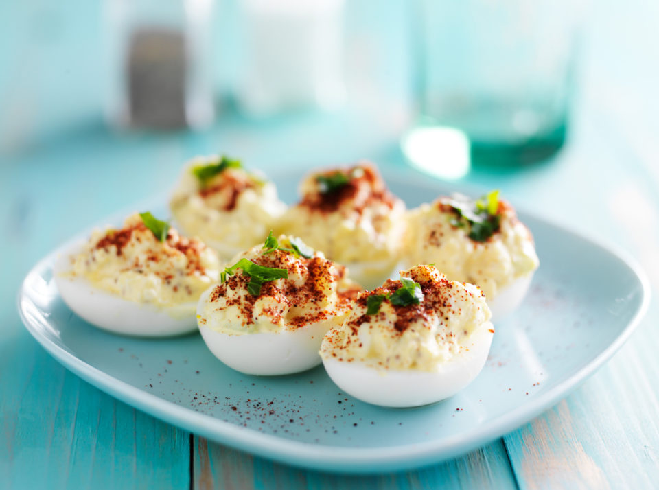 Deviled eggs with paprika and green onion garnish
