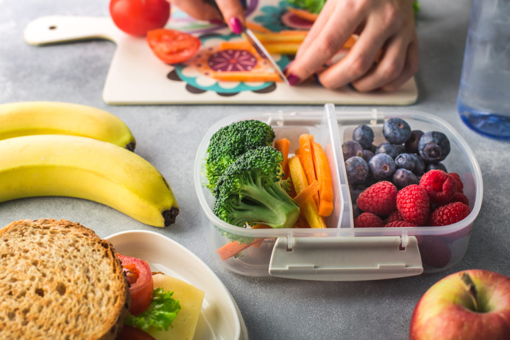 Mother giving healthy lunch for school