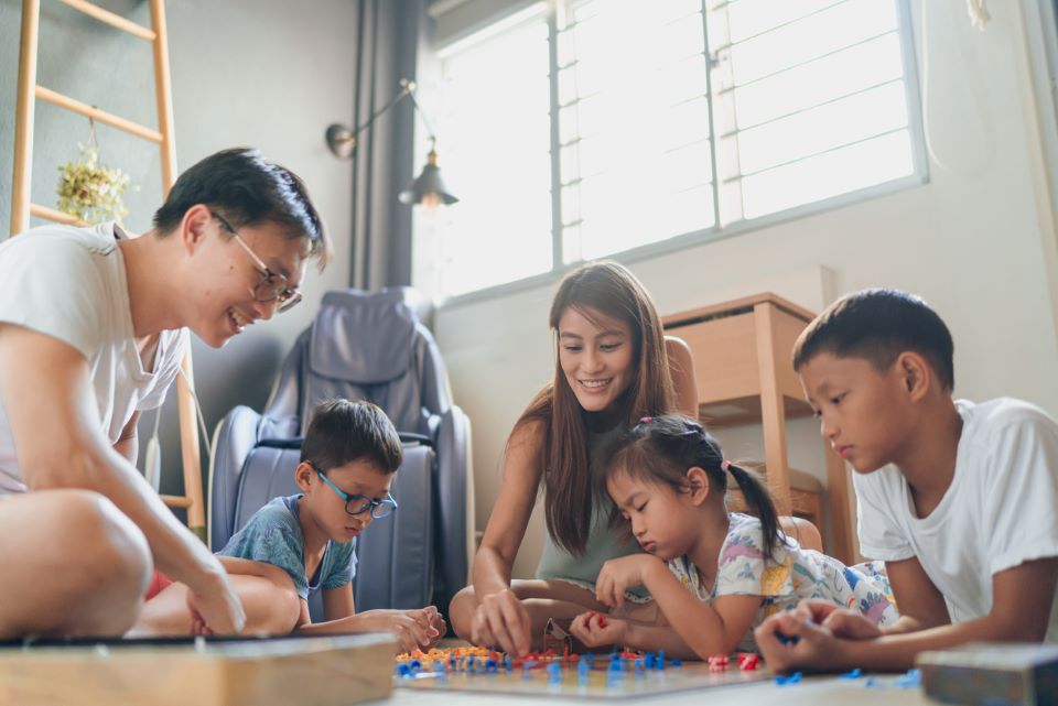 A family plays a board game together