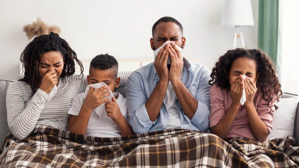 sick family blowing noses